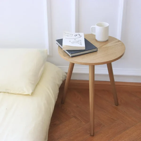 Small round wooden end table with a minimalist design. Perfect for living rooms, bedrooms, and bedside use. Easy to assemble and stylish.