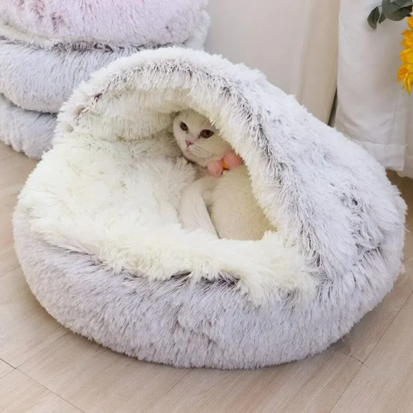 This Plush Hooded Pet Bed offers 2-in-1 comfort with a soft, fluffy cushion and a covered sleeping cave for cats and small dogs. Warm, cozy, and easy to clean!